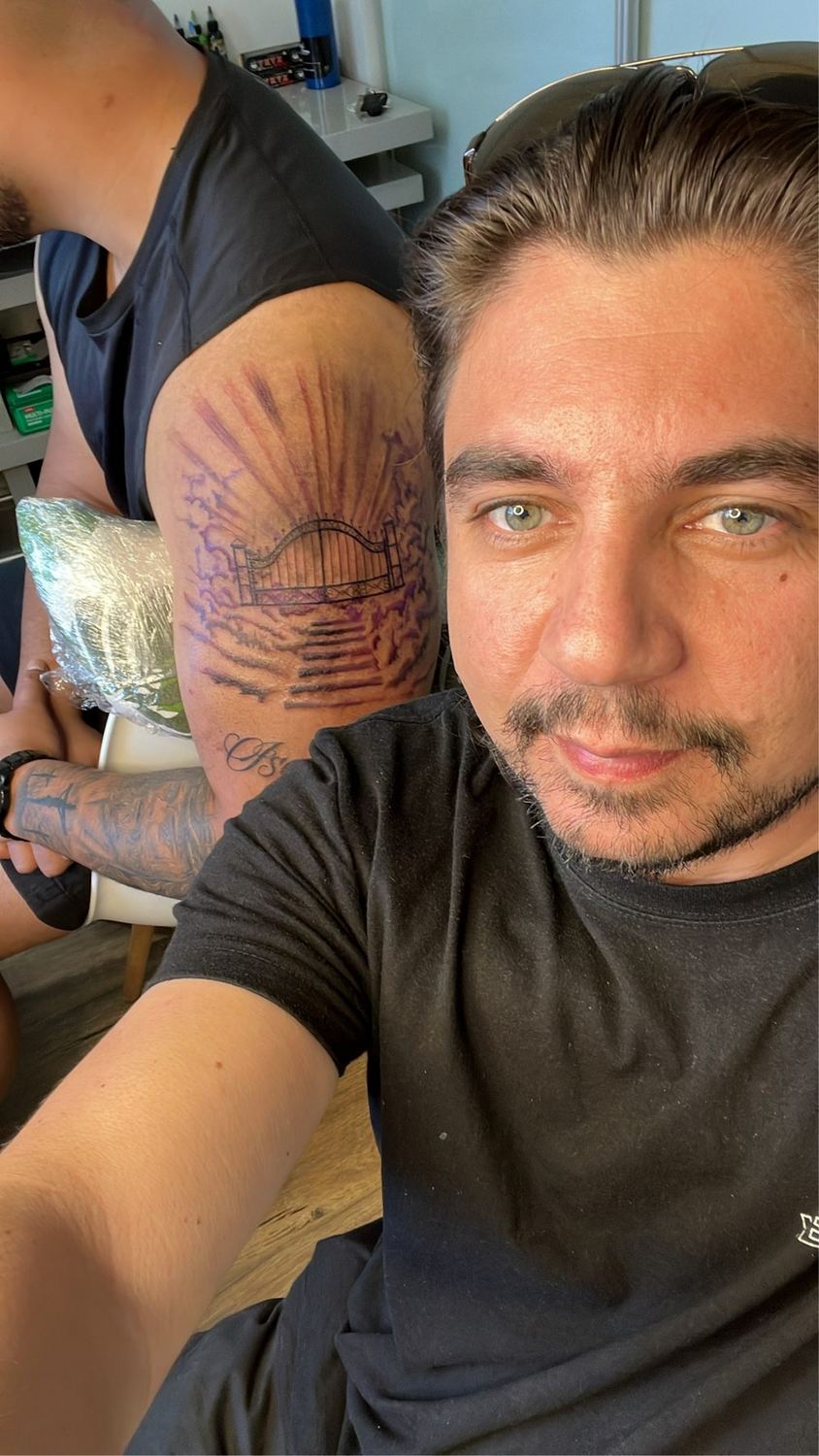 Scheklein Oleksandr with a client and a finished tattoo