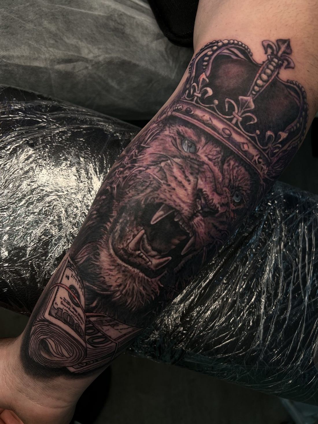 Black and grey crowned lion tattoo
