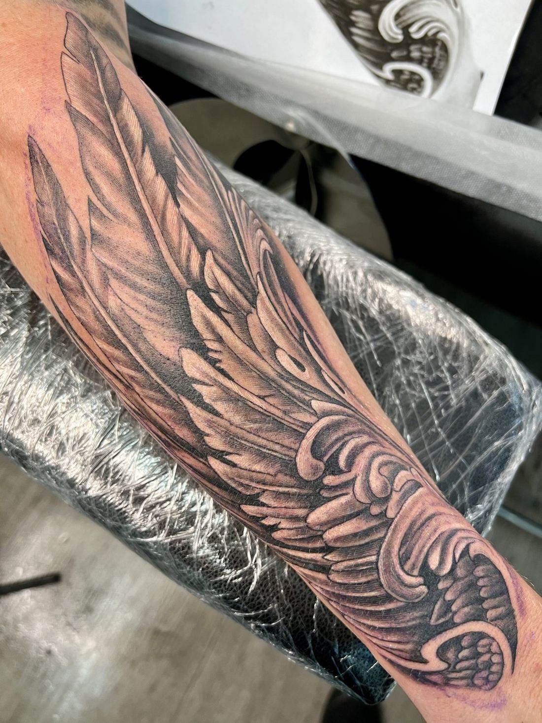 Tattoo: Black & grey realism — Filigree wing
