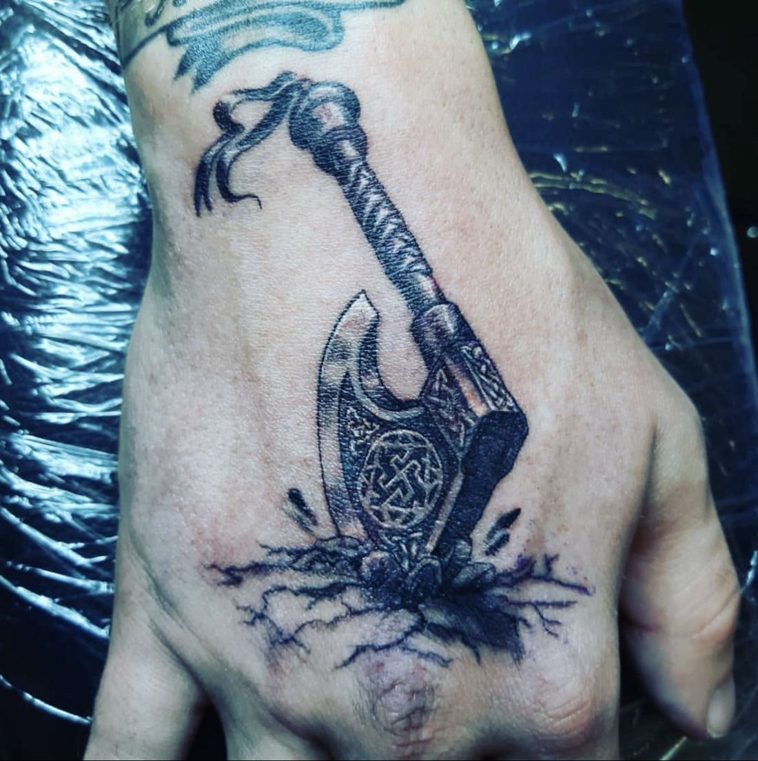 Tattoo: Black & grey — Viking axe hand piece