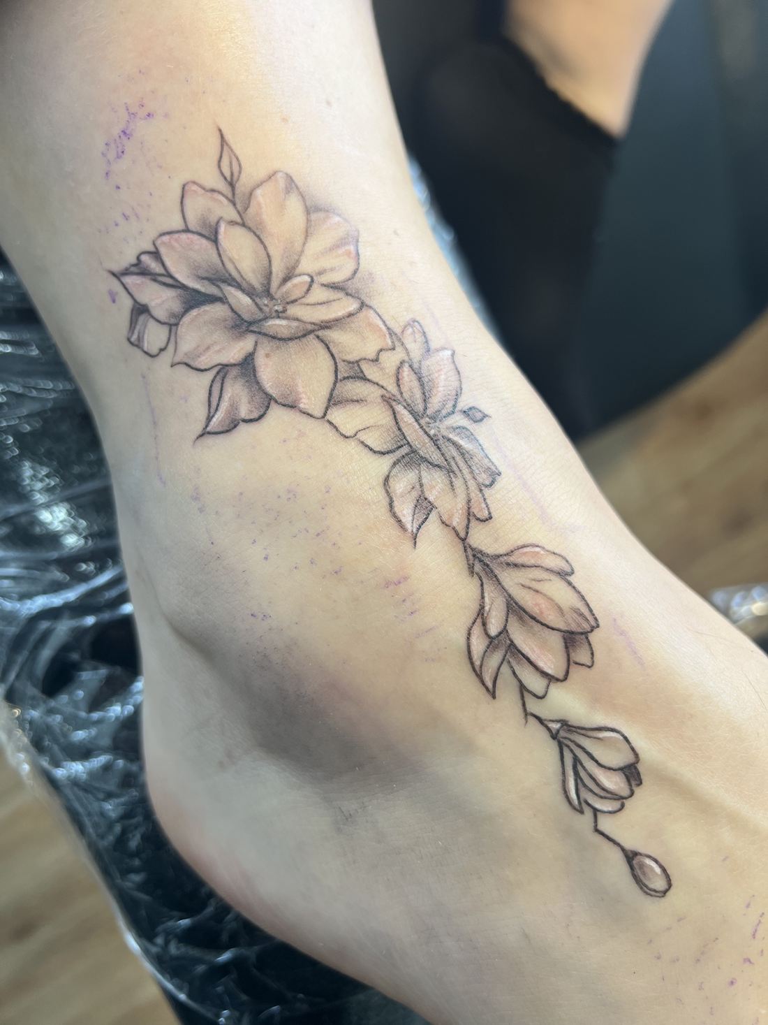 Tattoo: Black & grey fine line — Floral foot garland