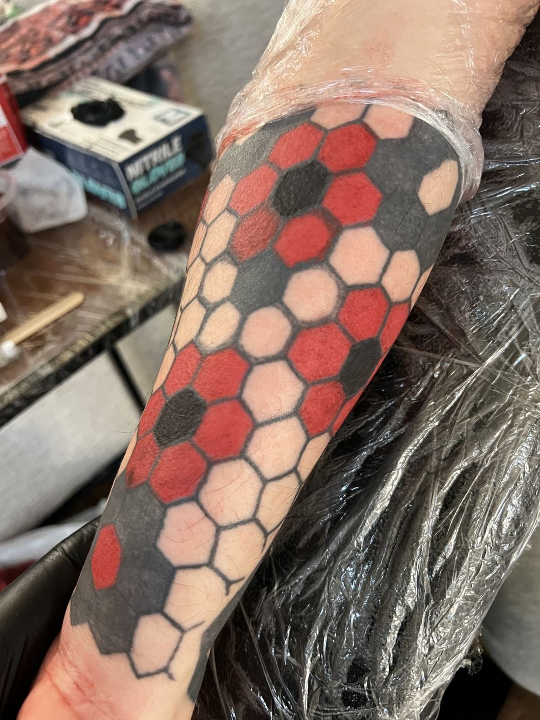 Tattoo: Color ornamental — Red and black honeycomb sleeve